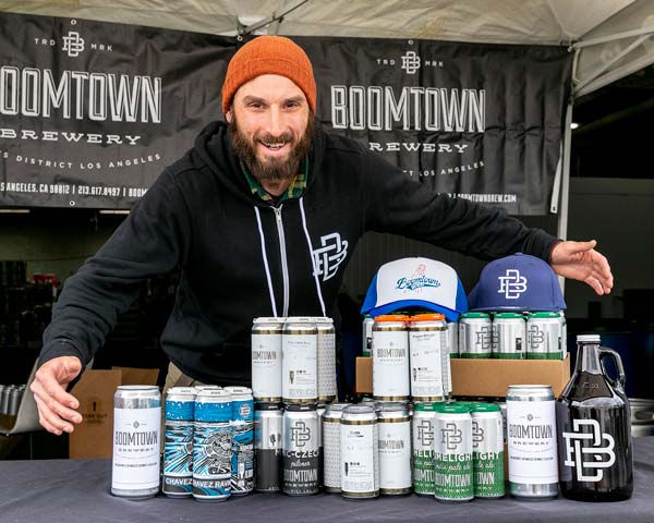 Brewer with stacks of beer cans