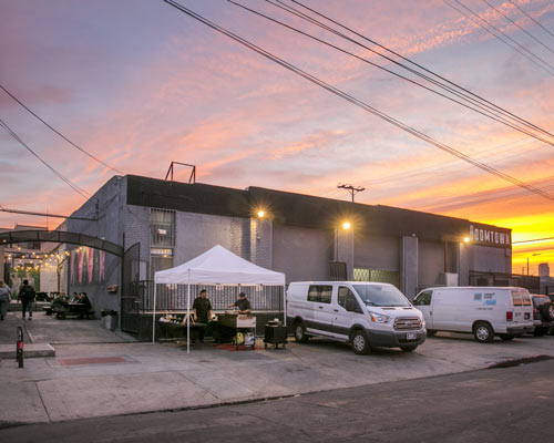 Boomtown Brewery building at sunset with a food vendor set up