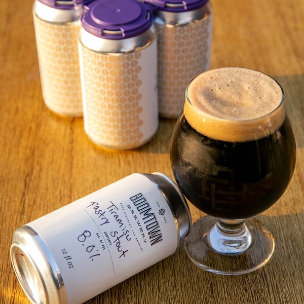 Glass and 12oz cans of Tiramisu Pastry Stout